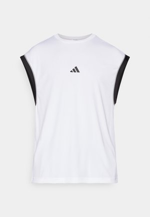 Valge sportlik tank top mustade õlaaktsentidega. Omab ümarat kaelust ning väikest musta logo ees. Sile kangas.