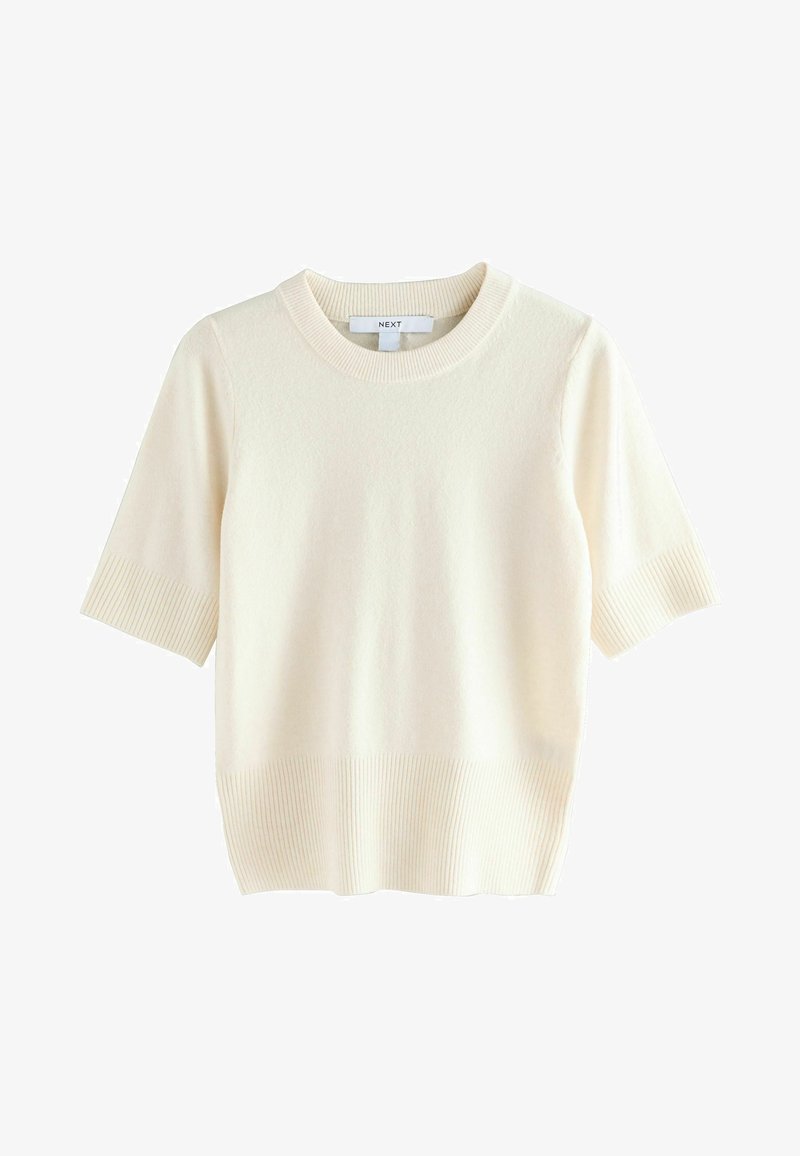 Pull à manches courtes, col rond en crème. Texture côtelée aux manches et à l'ourlet. Tissu en maille douce avec une finition lisse. Design léger.