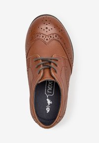 Brown leather lace-up shoe with brogue detailing, rounded toe, gray laces, and a textured insole featuring a logo.
