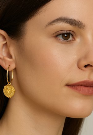 Gold hoop earrings featuring a lion head pendant with detailed facial features, textured surface, and a polished finish.