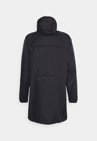 Black waterproof jacket with a hood, featuring a zippered back pocket, elastic cuffs, and a minimalist design. Smooth texture.