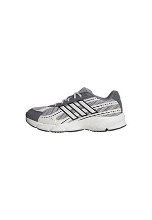 Grauer und weißer Sportschuh mit Mesh-Einsätzen, schwarzen Streifen und weißer Sohle, von der Seite auf weißem Hintergrund gezeigt.