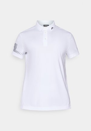 Hvit polo skjorte laget av et glatt, pustende stoff. Har en klassisk krage, knappeplacket, og et mønstrete akcent på venstre erme.