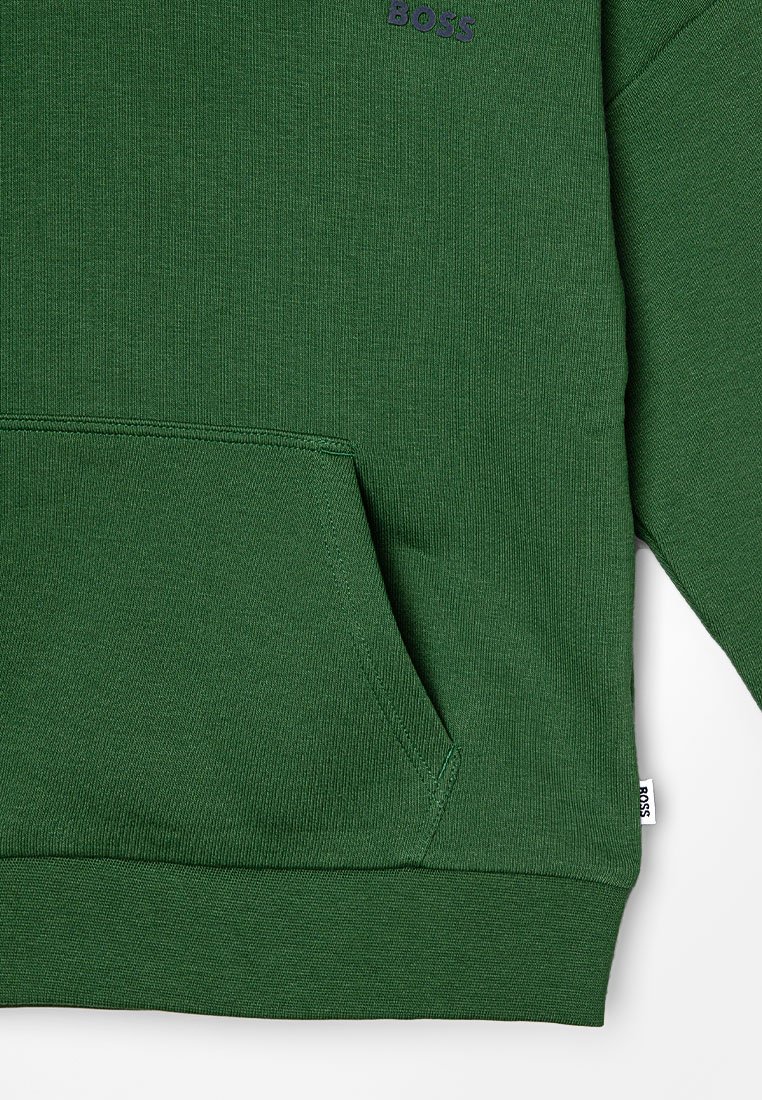 Felpa verde in tessuto a costine, con tasca a marsupio, logo in viola e polsini aderenti all'orlo. Dettagli di cucitura notevoli visibili.