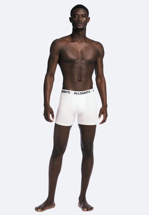 White boxer briefs with a black "ALLSAINTS" logo on the waistband. Material appears smooth and fitted, with a seamless design.
