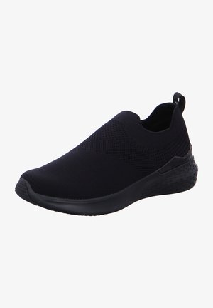 Zapato negro sin cordones con parte superior de punto texturizado, suela flexible y detalles de diseño geométrico en el talón. Cuenta con punta redondeada y sin cordones.