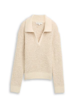 Kremowy sweter o teksturowanej powierzchni, z dekoltem w serek oraz prążkowanym kołnierzem i dołem. Posiada długie rękawy i luźny krój.