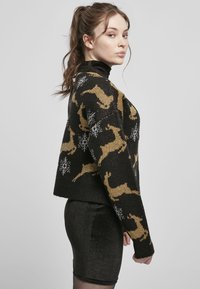 Black knitted sweater featuring a gold reindeer pattern with white snowflakes. Cropped style, textured fabric, long sleeves, and high neck.