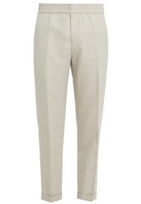 Light beige linen trousers with an elastic waistband, tapered legs, and folded cuffs. Features smooth texture and minimalistic design.
