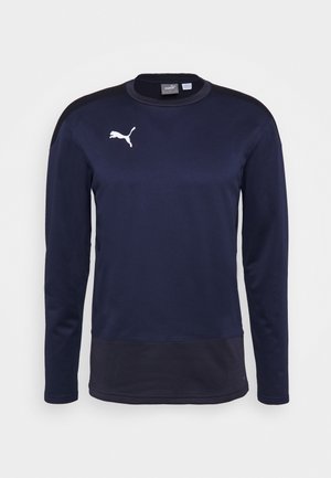 Granatowa sportowa bluza z długim rękawem z czarnymi akcentami, okrągłym dekoltem i białym logo Puma na prawym piersi.