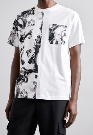 Chemise à manches courtes en noir et blanc avec un motif abstrait noir sur la moitié gauche et une poche poitrine assortie à motif sur le côté droit.