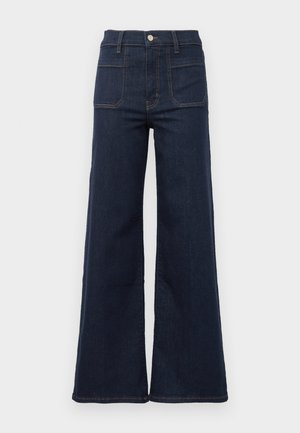 Dark blue flared jeans made from denim with a high waist, featuring two back pockets and contrasting stitching along the seams.