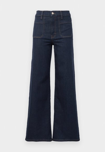 Dark blue flared jeans made from denim with a high waist, featuring two back pockets and contrasting stitching along the seams.