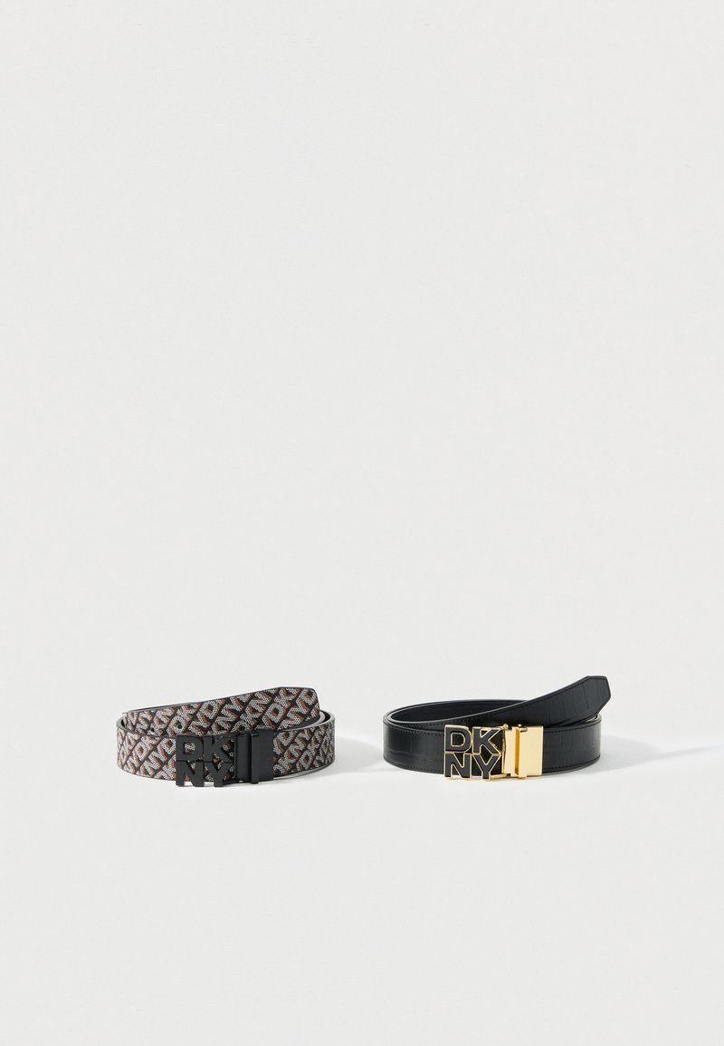 Deux ceintures DKNY côte à côte ; l'une à motif avec des logos marron et noirs et boucle noire, l'autre en cuir noir avec boucle dorée.