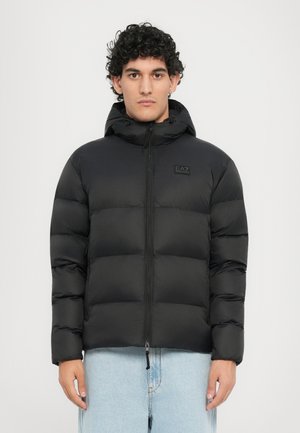 Black puffer jacket with a hood, featuring a quilted design, full zipper, and small logo on the chest. Smooth, lightweight material.