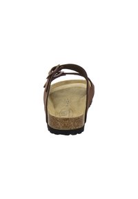 Brown leather sandal with an open back, cork footbed, and textured sole. Features a slender strap with a decorative loop detail.