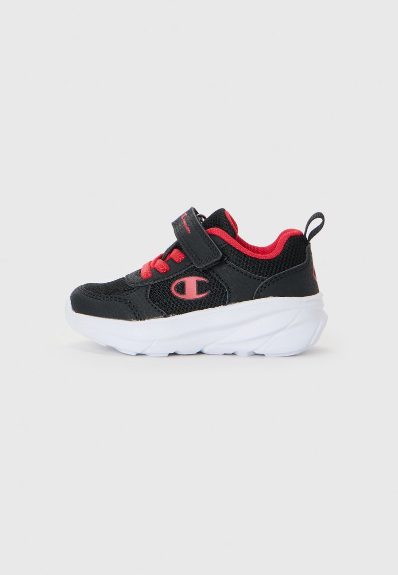 Black and red athletic shoes with mesh upper, padded collar, lace-up front, adjustable strap, and white rubber sole. Features logo on side.