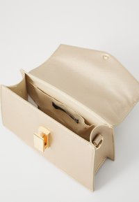 Beige synthetic handbag with a textured finish, featuring a gold-tone clasp and a lined interior pocket. Open design, rectangular shape.