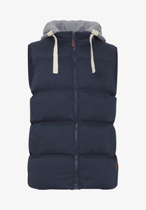 Marineblå puffer vest med aftagelig grå hætte, frontlynlås, tyk polstring, to sidelommer og mærkedetalje på brystet.