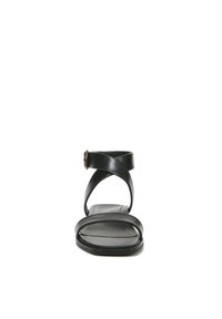 Zwarte leren sandaal met kruislingse banden, enkelgesp, open teenontwerp en platte zool. Voorzien van subtiele rode stiksels op de voetbed.