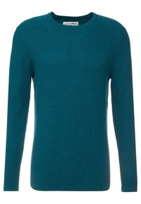 Knittröja i teal med rund halsringning, långa ärmar och ribbade muddar. Har ett subtilt strukturerat mönster och en liten märkesetikett vid fållen.