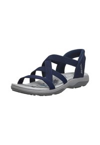 Sandali blu navy con fasce incrociate in tessuto, soletta ammortizzata e suola in gomma grigia con un motivo geometrico.