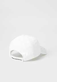 White baseball cap with a textured gray mesh visor. Features a back strap with "VERSACE JEANS COUTURE" label. Rounded crown design.
