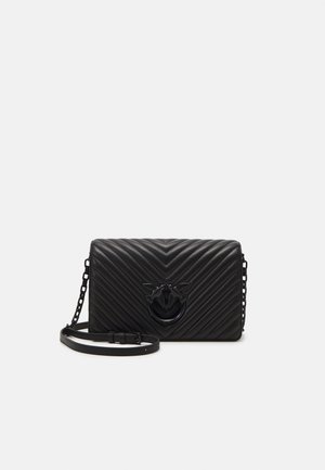 Black chevron-quilted leather bag with a chain and adjustable strap. Features a prominent black bee emblem on the front.