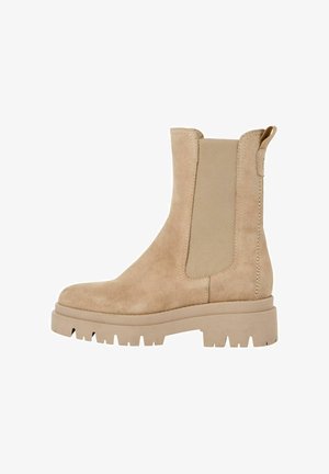 Beige Wildleder-Ankle-Boots mit elastischen seitlichen Einsätzen, einer kräftigen Plattformsohle und einer Zuglasche hinten für einfaches Anziehen.