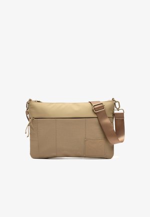 Beige crossbody bag with front zipper pocket, adjustable brown strap, and stitched rectangular patch on lower right corner.
