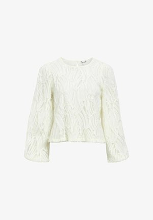 Blusa bianca corta con maniche lunghe, tessuto textured con motivi ondulati, scollo rotondo e chiusura a chiave sul retro.