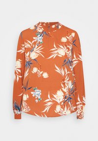 Blusa a maniche lunghe in colore ruggine, con motivi floreali in bianco, rosa e blu. Collo alto con dettagli arricciati e maniche con polsini.