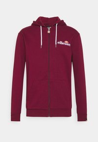 Burgunderfarbene Full-Zip-Kapuzenjacke mit weißen Kordeln, Fronttaschen und weißem "ellesse"-Logo mit orangefarbenem Halbkreis auf der linken Brust.