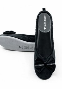 Ballerines en tissu noir avec un détail en nœud orné de strass, une semelle intérieure grise rembourrée et une texture lisse globale.