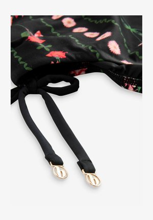 Black floral-patterned swimwear trim featuring adjustable black straps with gold-tone hardware accents. Soft fabric texture, vibrant design.