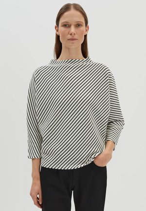 Black and white diagonal striped sweater with a boat neckline and three-quarter sleeves, featuring a relaxed fit and textured fabric.