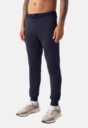 REGULAR FIT - ATHLEISURE CUFFED JOGGERS . - Pantalones deportivos - navy blue