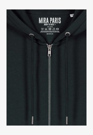 Bluza z kapturem na suwak w ciemnozielonym bawełnianym materiale, z metalowym zamkiem YKK, sznurkami do ściągania i metką z nazwą marki oraz instrukcjami pielęgnacji.