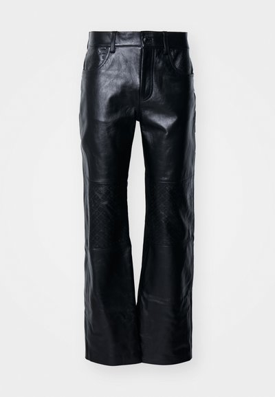 Μαύρο δερμάτινο παντελόνι με φαρδιά πόδια, με υφή λεία και τμήματα με ραφή καπιτονέ. Κλασικός σχεδιασμός με κούμπωμα και φερμουάρ.