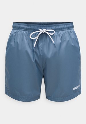 Modré plavkové šortky z lehkého materiálu s elastickým pasem se stahovací šňůrkou v bílé barvě a malým bílým logem.