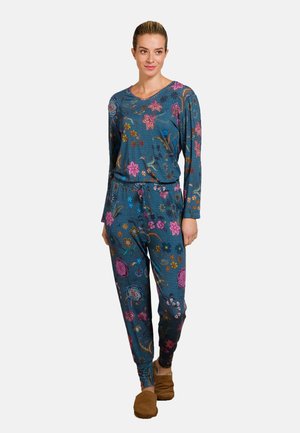 Floral-patterned loungewear set in teal, featuring a long-sleeve top and jogger pants with an elastic waistband and soft fabric. Brown slippers.