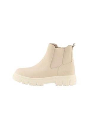 Bottine beige avec des panneaux élastiques sur les côtés, en tissu texturé, et une épaisse semelle en caoutchouc blanc. Elle présente une languette pour un enfilage facile.