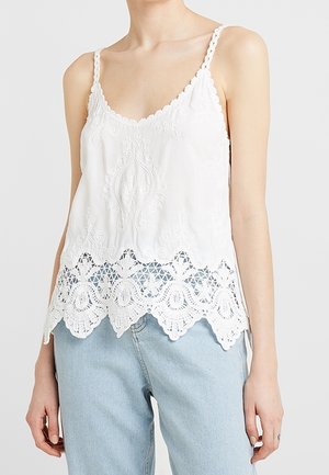 Bílý vyšívaný top na ramínka s krajkovým lemem na spodním okraji a nastavitelnými tenkými ramínky. Volný střih s propracovanými detaily podél krajky.