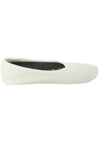 Flat white shoe with a textured synthetic upper, rounded toe, and elasticated opening. Sole is smooth and slightly thicker for comfort.