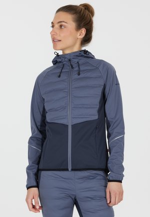 Lightweight, two-tone jacket made of soft, weather-resistant fabric. Features a zip front, hood, and elastic cuffs. Includes side pockets.