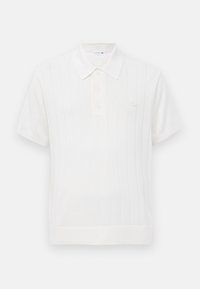 White knitted polo shirt with short sleeves, featuring a subtle ribbed texture, three button placket, and a small logo on the chest.