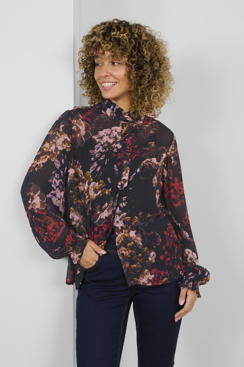 Blusa fluida e trasparente nera con un motivo floreale in rosso, rosa e marrone. Presenta maniche lunghe e un colletto alto con dettagli a bottoni.