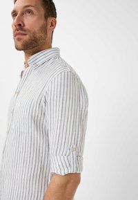 Men's button-up shirt in light gray and white stripes; features a collared neckline, single chest pocket, and rolled sleeves with button detail.