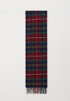 Woven plaid scarf in red, green, and navy with yellow accents. Features fringed ends and a soft, textured fabric.