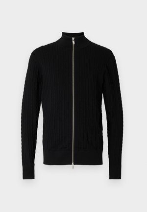 Schwarzer Reißverschluss-Pullover aus strukturiertem Stoff mit gerippten Designs. Mit hohem Kragen und langen Ärmeln, in taillierter Silhouette.